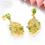 side view of peridot citrine and zircon leaf earrings in 18k yellow gold over sterling silver