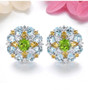 peridot citrine blue topaz and zircon cluster stud earrings in rhodium over sterling silver shown in a lifestyle photo