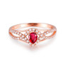 front view of ruby and diamond infinity design ring in 14k rose gold