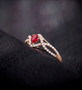 ruby and diamond infinity design ring in 14k rose gold shown in a lifestyle photo