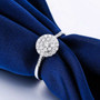 round diamond round cluster ring in 14k white gold shown in a lifestyle photo