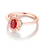 side view of ruby and diamond halo ring in 14k rose gold