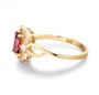 side view of pink tourmaline and diamond halo ring in 18k yellow gold