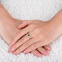 tsavorite garnet and diamond ring in 18k rose gold worn on a hand
