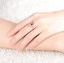 regal pink tourmaline and diamond ring in 18k rose gold worn on a hand