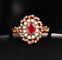 ruby and diamond halo ring in 18k rose gold shown in a lifestyle photo