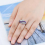 sky blue topaz and amethyst ring in rhodium over sterling silver worn on a hand