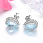 angled view of aquamarine and diamond pear halo earrings in 14k white gold