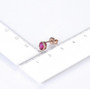 unheated ruby oval bezel set stud earrings in 14k rose gold shown for size comparison