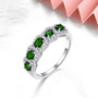 chrome diopside and zircon band ring in rhodium over sterling silver shown in a lifestyle photo