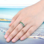 chrome diopside and zircon band ring in rhodium over sterling silver worn on a hand