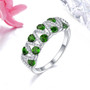 chrome diopside and white zircon openwork ring in rhodium over sterling silver shown in a lifestyle photo