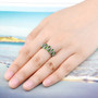 chrome diopside and white zircon openwork ring in rhodium over sterling silver worn on a hand