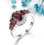 garnet and white zircon ring in rhodium over sterling silver shown in a lifestyle photo