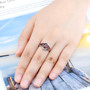 garnet and white zircon ring in rhodium over sterling silver worn on a hand