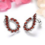 side view of garnet and white zircon earrings in rhodium over sterling silver