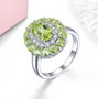peridot and white zircon halo ring in rhodium over sterling silver shown in a lifestyle photo