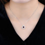 dancing garnet and zircon round double halo pendant necklace in rhodium over sterling silver worn around the neck