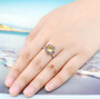 citrine and amethyst halo ring in rhodium over sterling silver worn on a hand