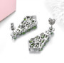 back view of chrome diopside and white zircon dangle earrings in rhodium over sterling silver