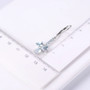 sky blue topaz heart dangle earrings in rhodium over sterling silver shown for size comparison