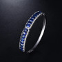 sapphire and diamond bangle bracelet in 18k white gold shown in a lifestyle photo