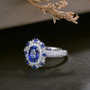 sapphire and diamond double halo ring in 18k white gold shown in a lifestyle photo
