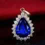 tanzanite and diamond halo necklace in 14k yellow gold shown in a lifestyle photo