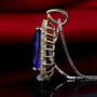 full view of tanzanite and diamond halo necklace in 14k yellow gold