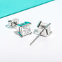 close up of white or black moissanite princess cut stud earrings in 10k white gold
