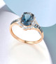 london blue topaz and diamond ring in 14k rose gold shown in a lifestyle photo