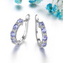 tanzanite and white zircon hoop earrings in rhodium over sterling silver shown in a lifestyle photo