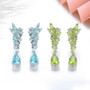 close up of sky blue topaz dangle earrings in rhodium over sterling silver