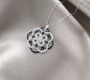black spinel and cubic zirconia cluster necklace in black and white rhodium over sterling silver shown in a lifestyle photo