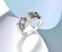 cubic zirconia flower ring in black and white rhodium over sterling silver shown in a lifestyle photo