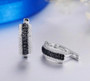 close up of black spinel and white zircon hoop earrings in black and white rhodium over sterling silver