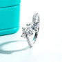 moissanite double heart bypass ring in rhodium over sterling silver shown in a lifestyle photo