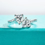 front view of moissanite double heart bypass ring in rhodium over sterling silver
