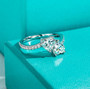 close up of moissanite double heart bypass ring in rhodium over sterling silver