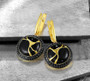 black spinel black marble enamel earrings in 18k yellow gold over sterling silver shown in a lifestyle photo