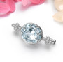 close up of aquamarine and white zircon rhodium over sterling silver brooch
