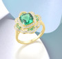 lab created green spinel and cz halo ring in 18k yellow gold over sterling silver shown in a lifestyle photo