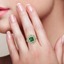 lab created green spinel and cz halo ring in 18k yellow gold over sterling silver worn on a hand
