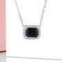 sapphire and white zircon halo necklace in rhodium over sterling silver shown in a lifestyle photo