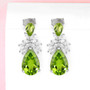 peridot and white zircon dangle earrings in rhodium over sterling silver shown in a lifestyle photo