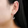 sapphire and white zircon dangle earrings in rhodium over sterling silver worn on the ear
