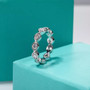 close up of moissanite eternity scalloped band ring in rhodium over sterling silver