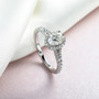 moissanite oval halo ring in rhodium over sterling silver shown in a lifestyle photo