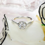 front view of moissanite round heart side gallery ring in rhodium over sterling silver