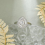 front view of pear moissanite baguette and round halo ring in rhodium over sterling silver